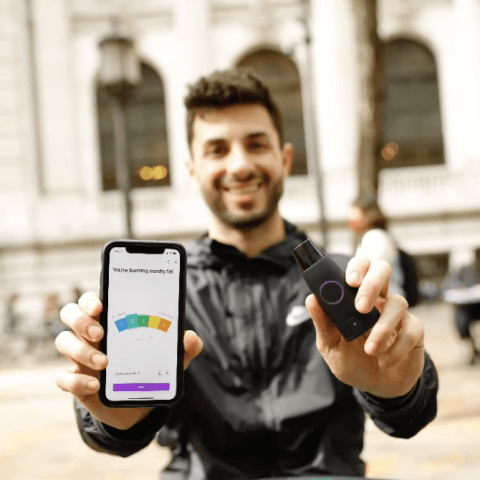 A man holding a Lumen device