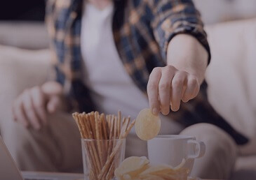 A man snacking on French fries